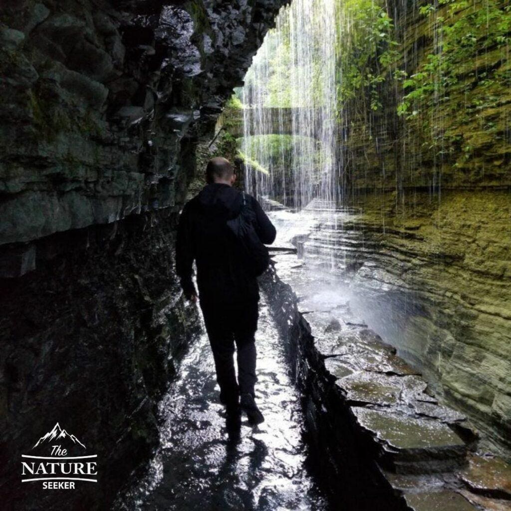 underneath rainbow falls in watkins glen state park